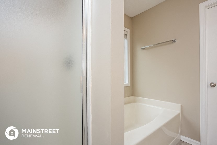 a small bathroom with a tub and a shower