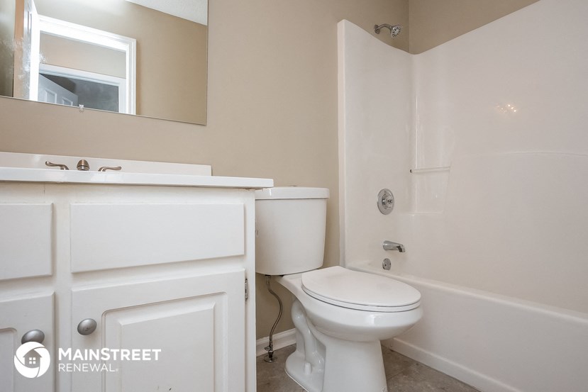 a bathroom with a toilet and a sink and a bath tub