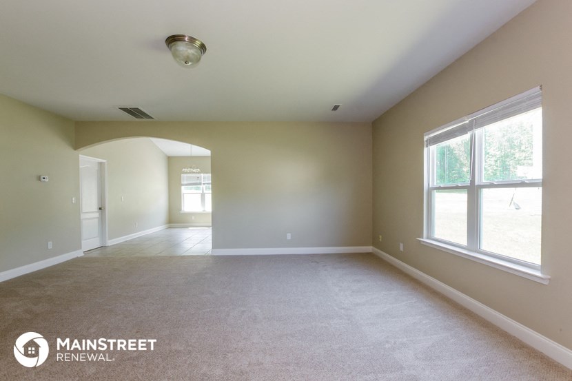 an empty living room with a large window