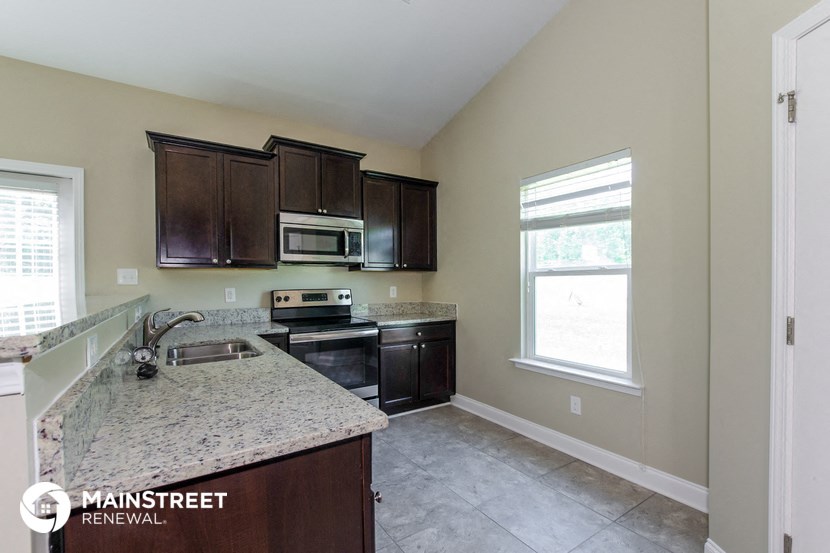 a kitchen with black appliances and granite counter tops