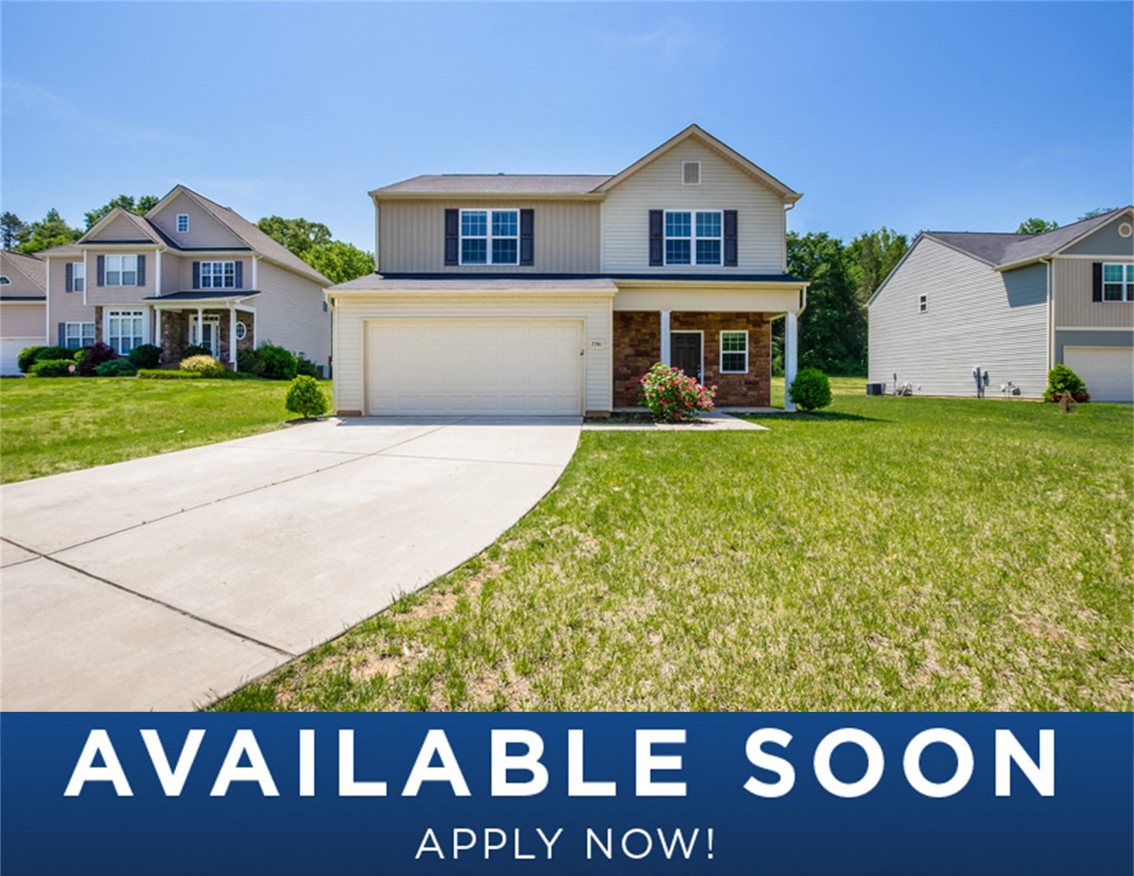 a beige house with a lawn and a driveway