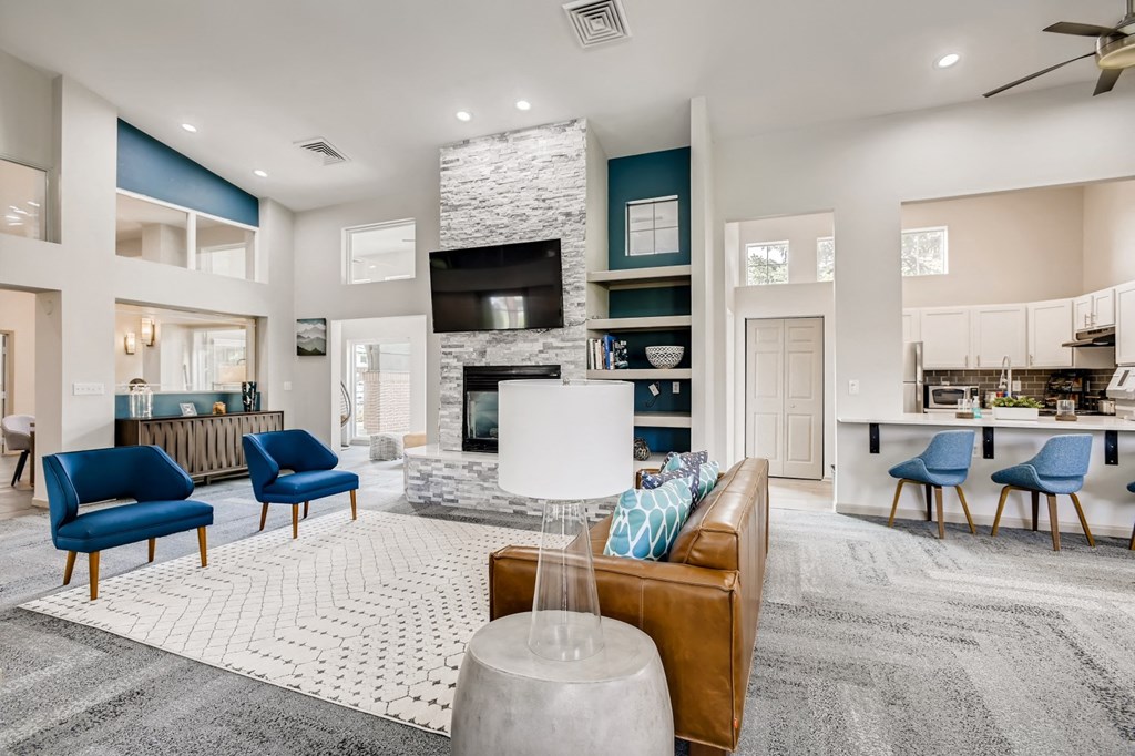 a living room with a couch and chairs and a fireplace
