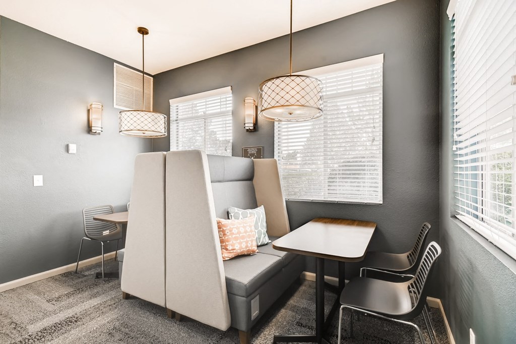 a living room with a couch and a table and chairs