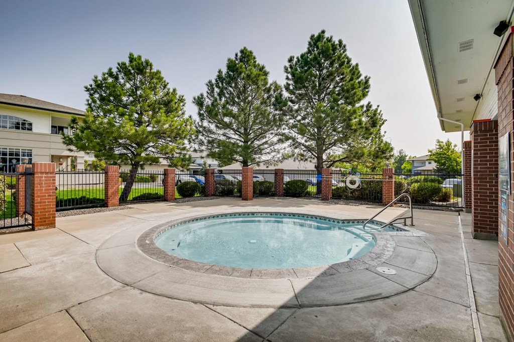 the preserve at ballantyne commons pool and spa with trees and a building