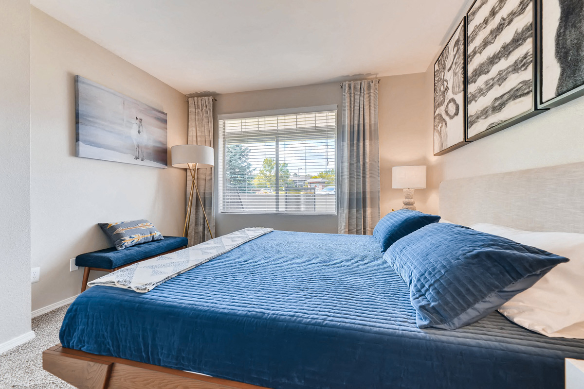 a bedroom with a large bed and a window