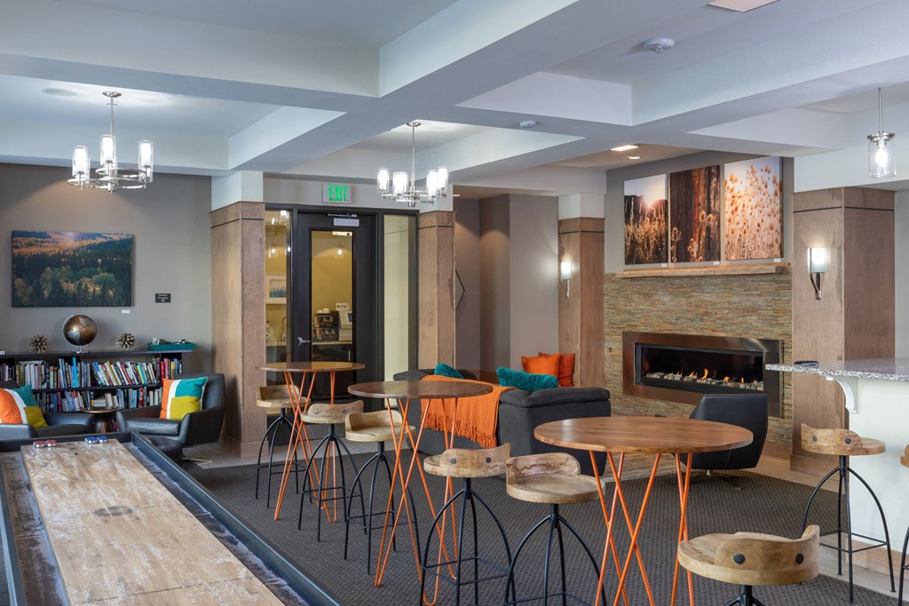 a living room with tables and chairs and a fireplace