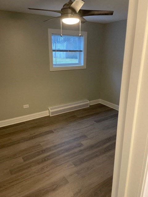 a empty room with a ceiling fan and a window