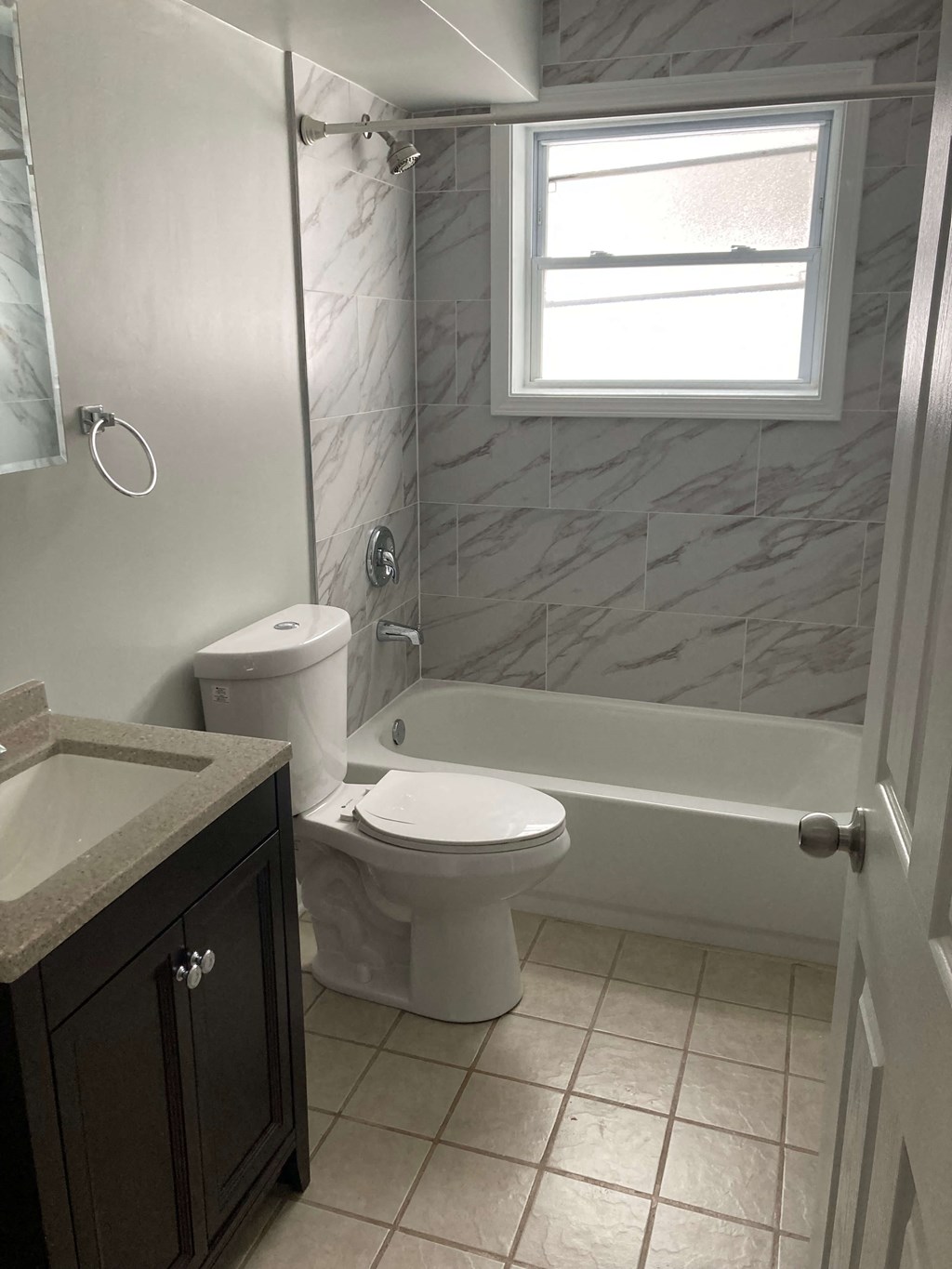 a bathroom with a toilet and a tub and a sink