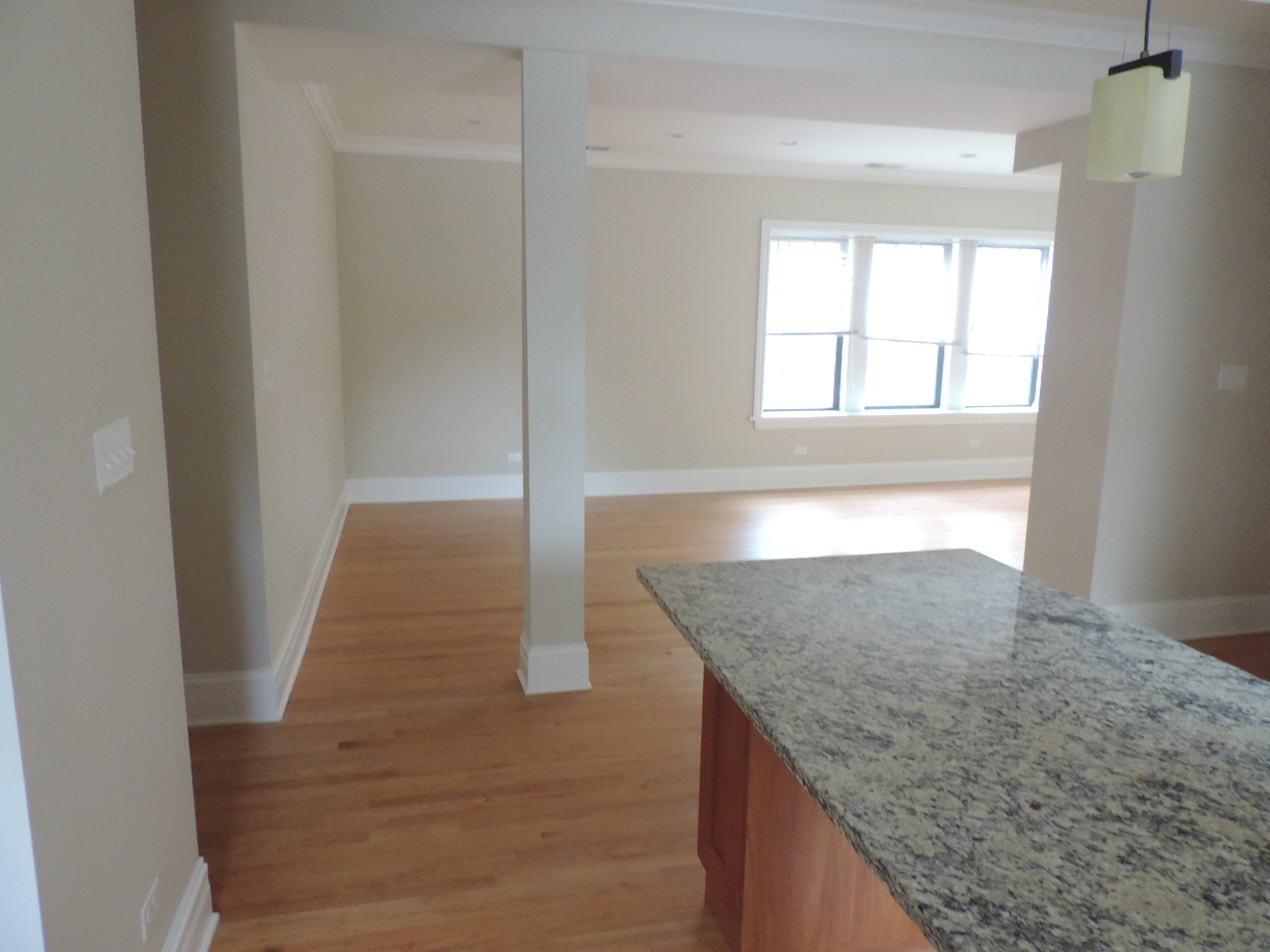 an empty living room with an island in the middle of it