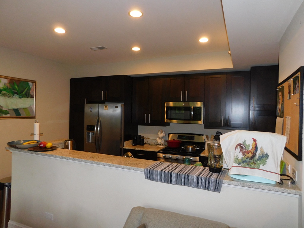 a kitchen with a counter top and a stove and a refrigerator