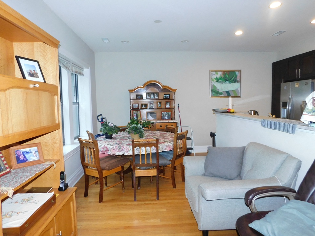 a living room and dining room with a table and chairs