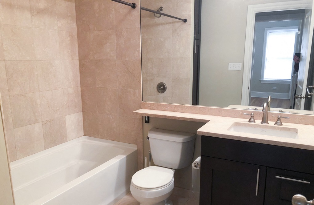 a bathroom with a toilet and a sink and a bath tub