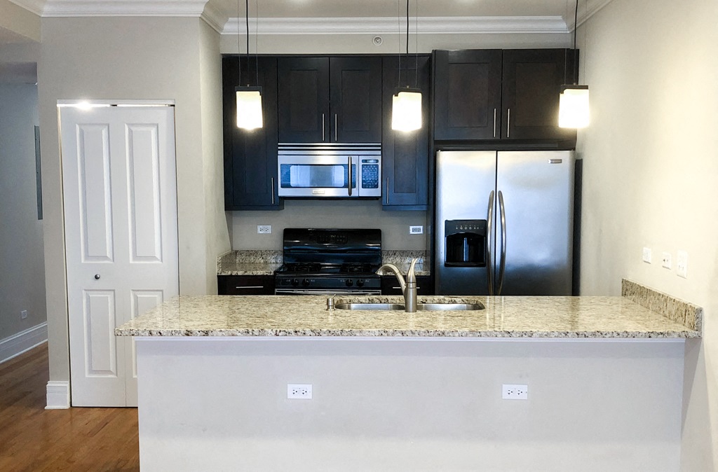 a kitchen with a counter top and a refrigerator