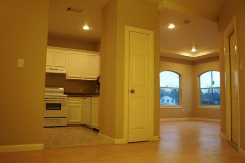 A kitchen with white appliances and cabinets.