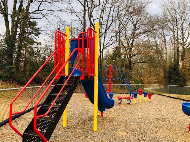 a playground with a swing set and slides
