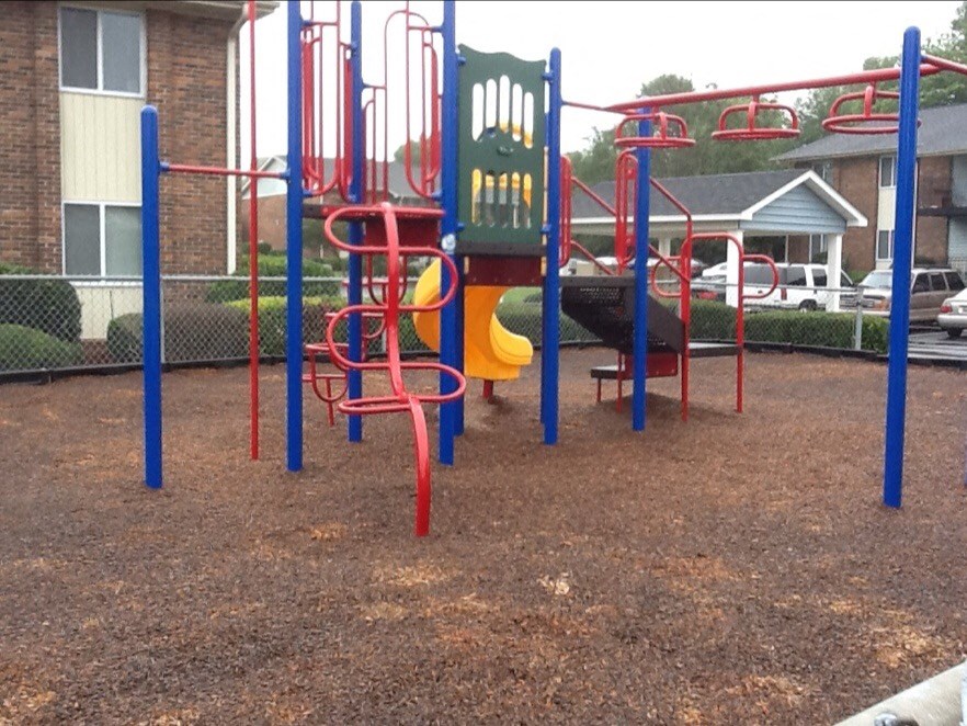 a playground with a slide and monkey bars in a park