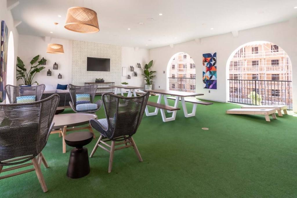 a large room with tables and chairs and green carpet