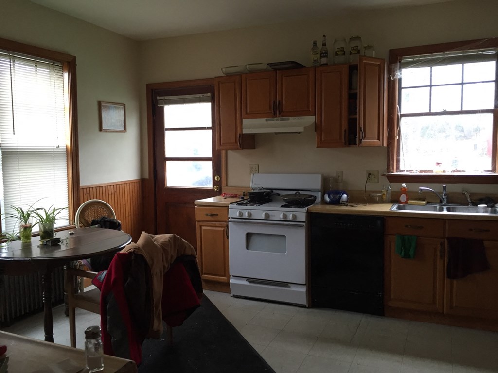 A kitchen with a stove and a table.