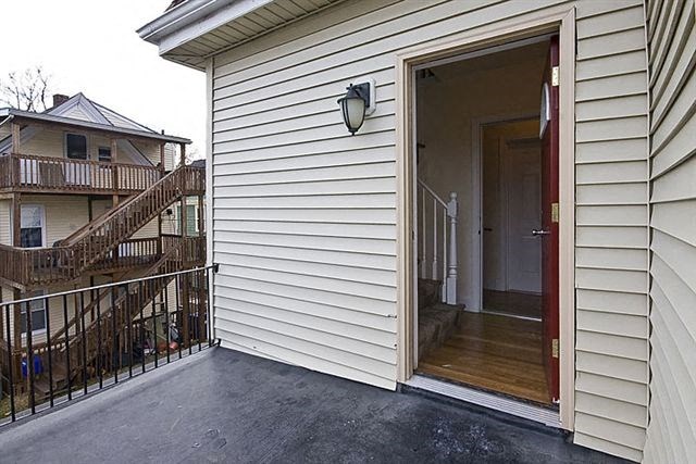 a white house with a porch and a door