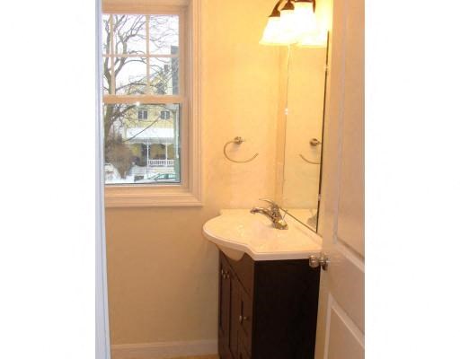 a bathroom with a sink and a mirror and a window