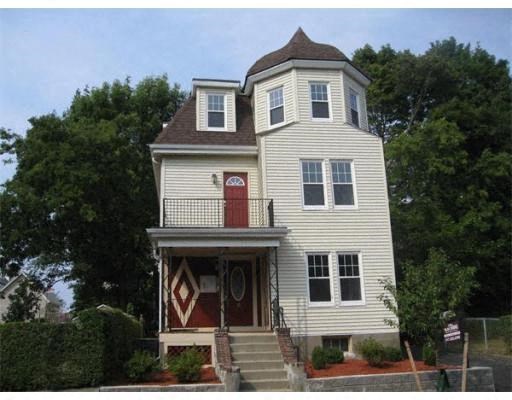 a white house with a red door and a