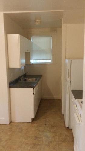 a small kitchen with a sink and a window