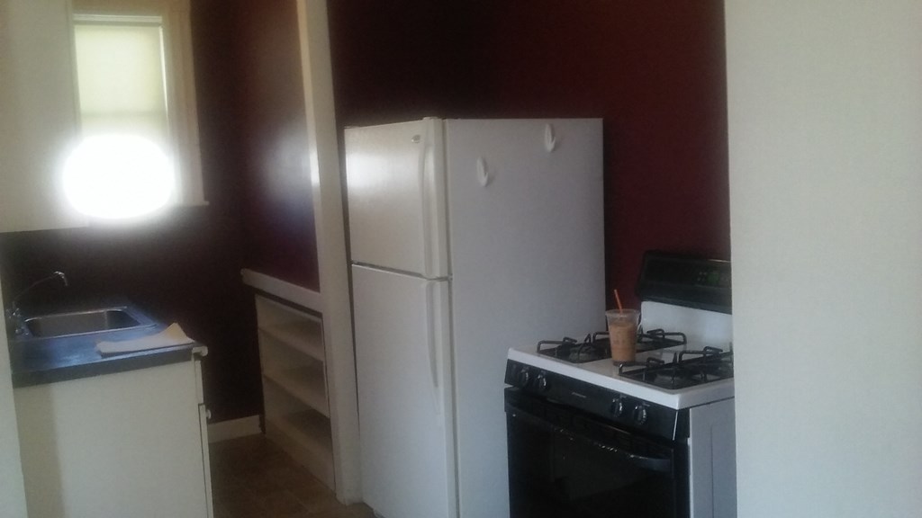 a kitchen with a stove and a refrigerator