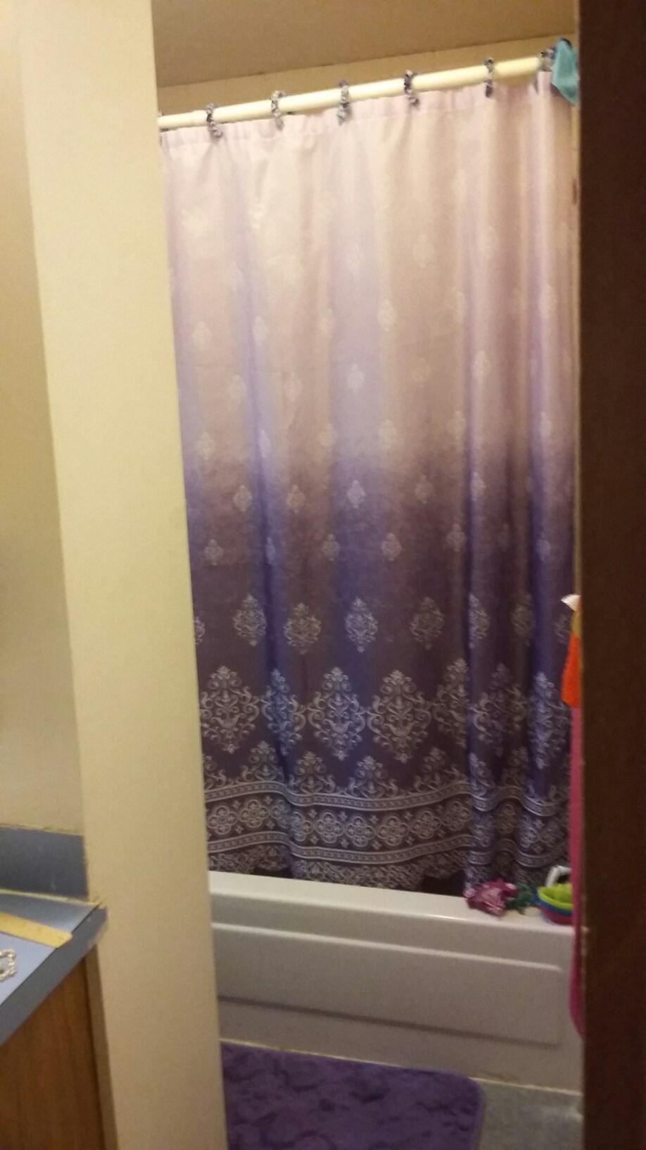 a bathroom with a shower curtain and a bath tub