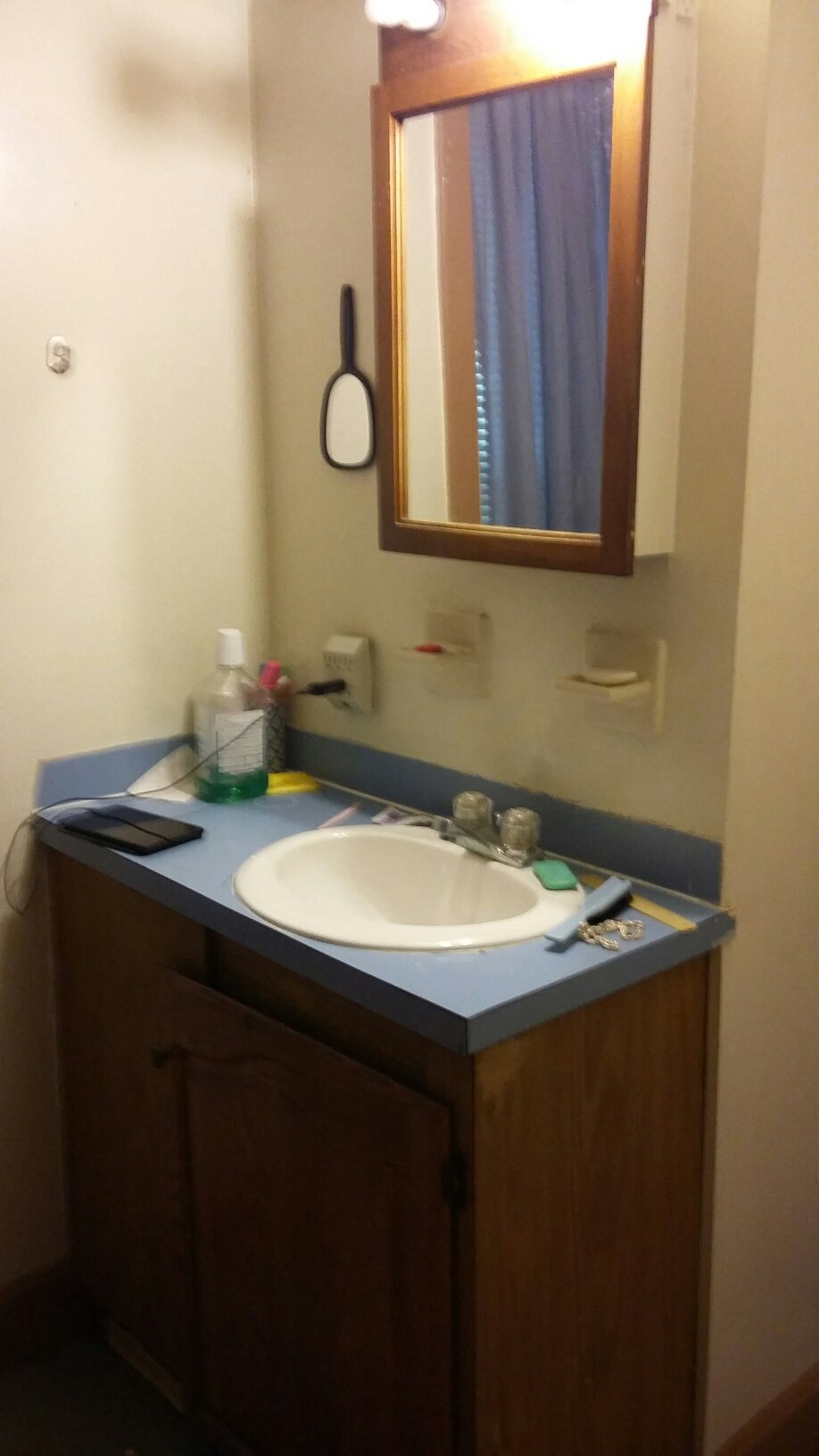 a small bathroom with a sink and a mirror