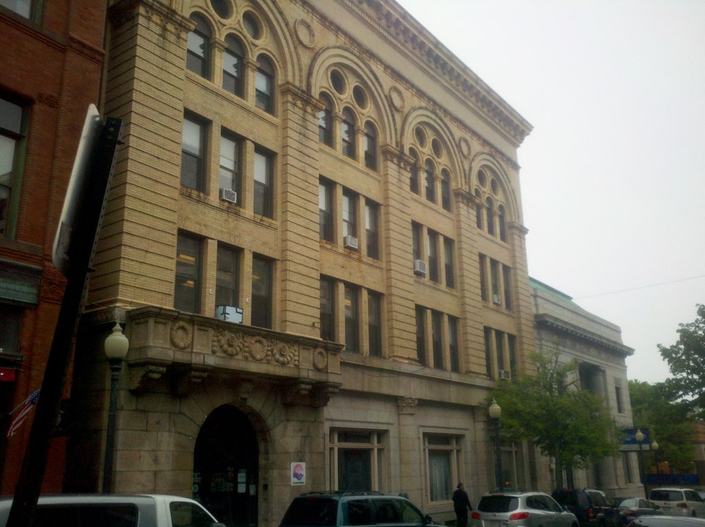 an old building on the corner of a city street