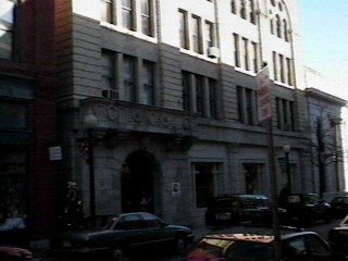 a large building on a city street with cars