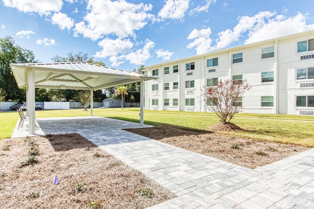 courtyard with paved walkway and pavilion with chairs