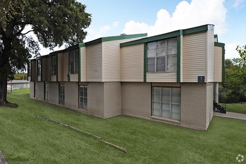 the side of a building with a green and white roof