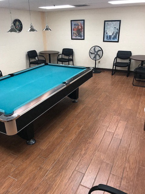 game room with pool table and tables and chairs