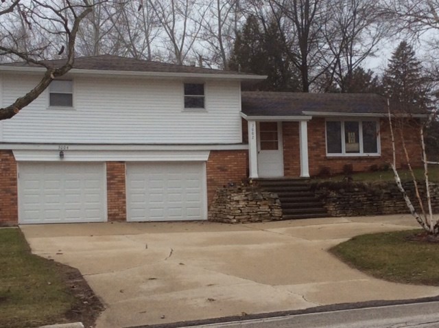 a white house with a driveway in front of it