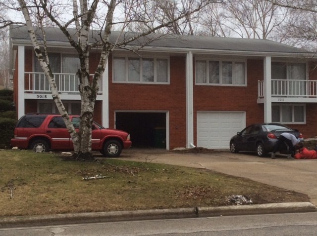 a house with two cars parked in front of it