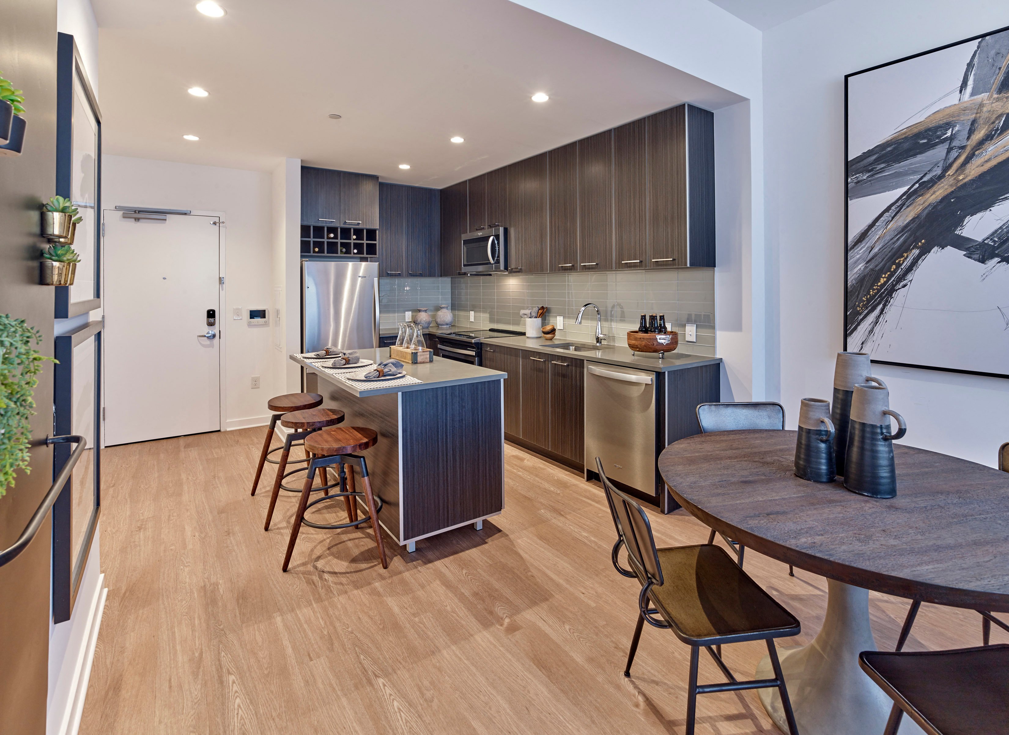 A modern kitchen with a dining table and chairs.
