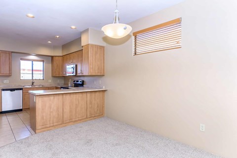 A kitchen with wooden cabinets and a white countertop.
