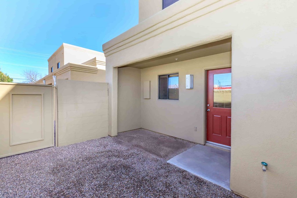 A house with a red door and a brown garage door.