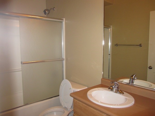 a bathroom with a sink toilet and a shower