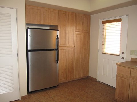 a kitchen with a stainless steel refrigerator and a door