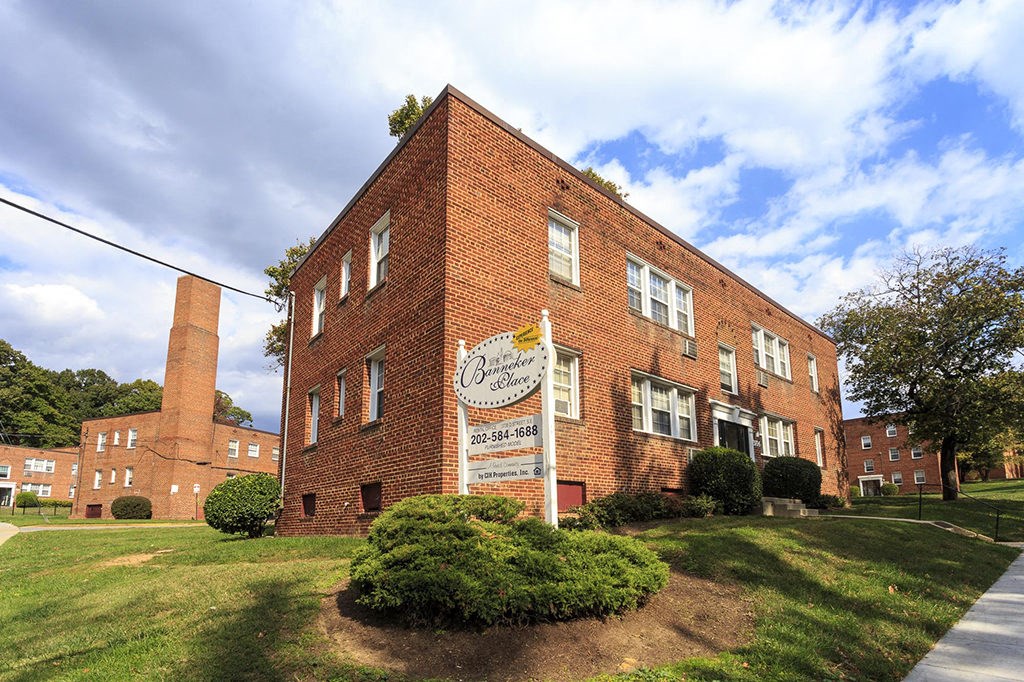 a large brick building with a sign in front of it