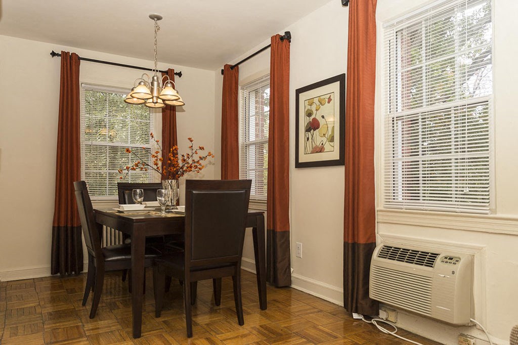 a dining room with a table and chairs and a window