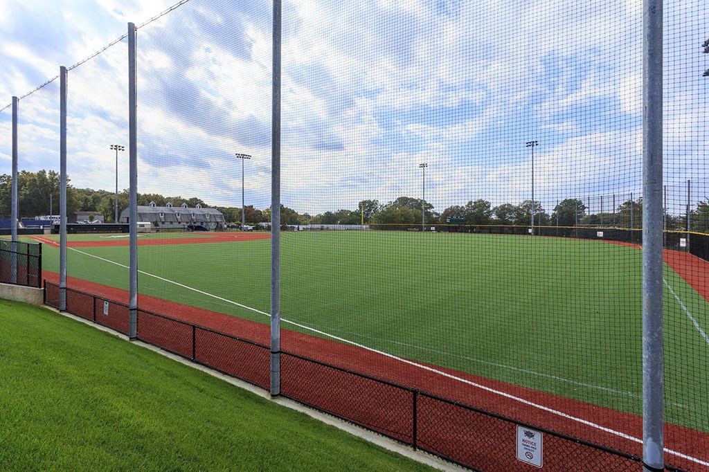 a view of a soccer field from behind the fence