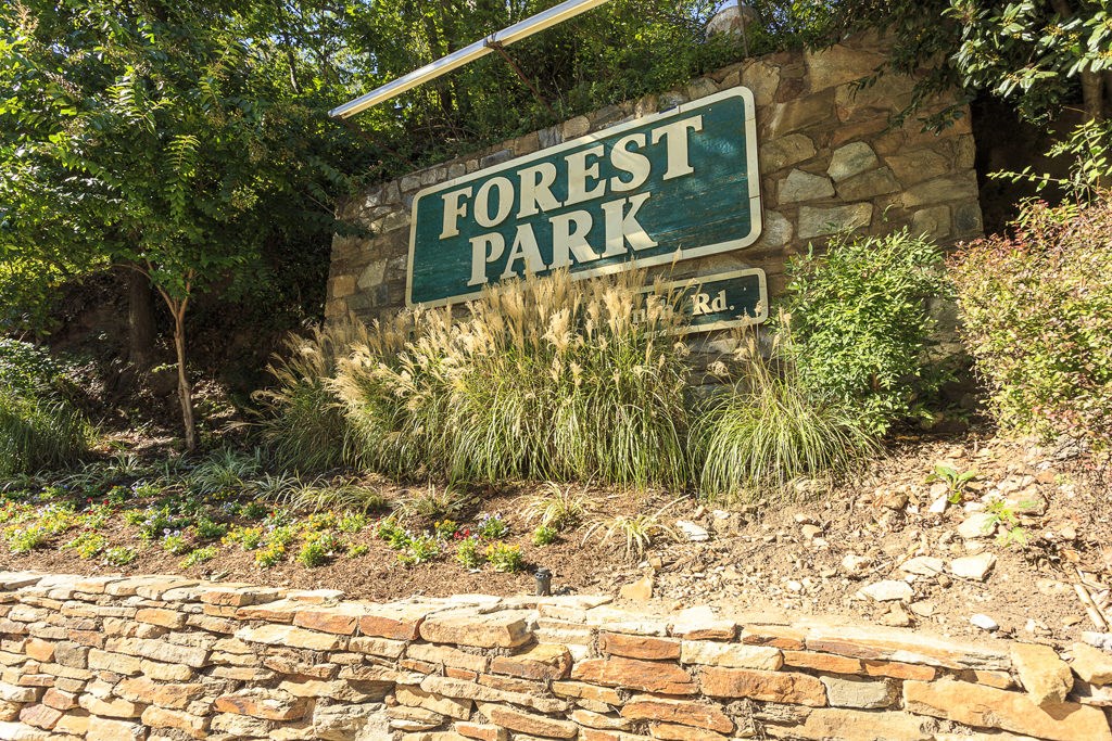 a sign for forest park on the side of a stone building