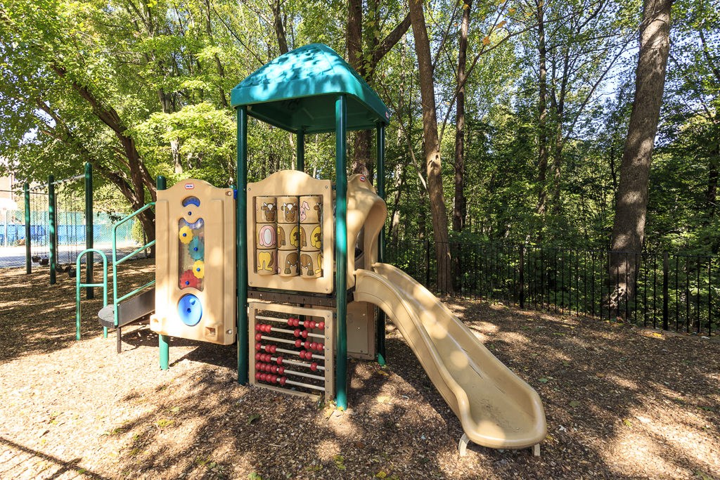 a playground with a slide in a park