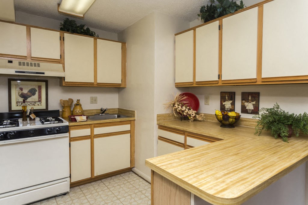 a kitchen with white appliances and wooden counter tops