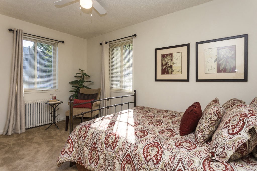 a bedroom with a bed and some pictures on the wall