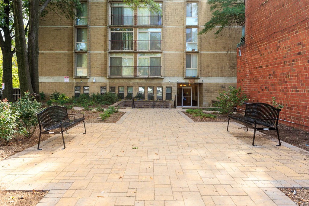 a brick building with two benches in front of it