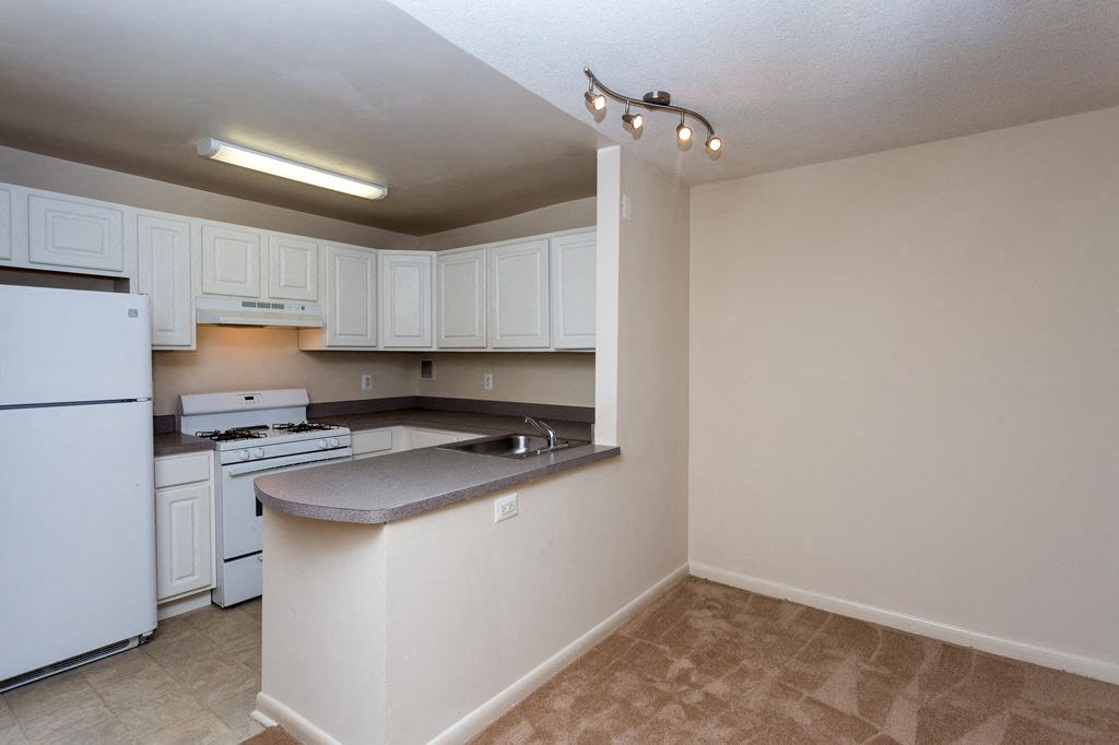 a kitchen with white cabinets and a counter top